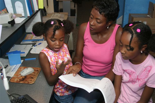 mom and daughters reading